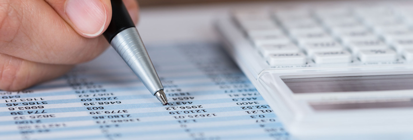 Person highlighting a section on a report with a pen
